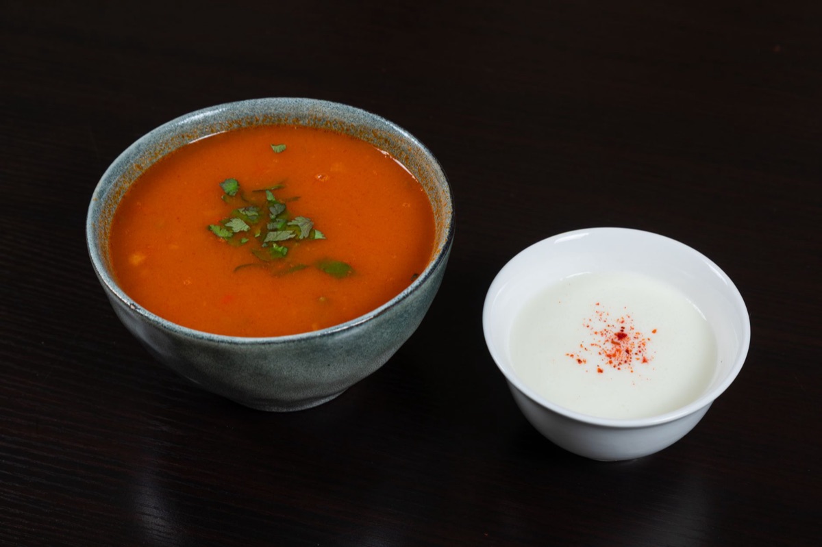 Lentil soup with vegetables in white bowl
