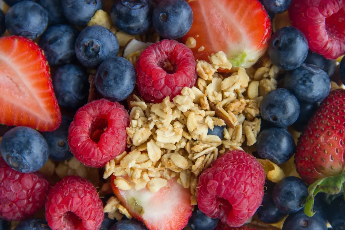 A vibrant close-up of mixed berries and granola, highlighting fresh nutrition.
